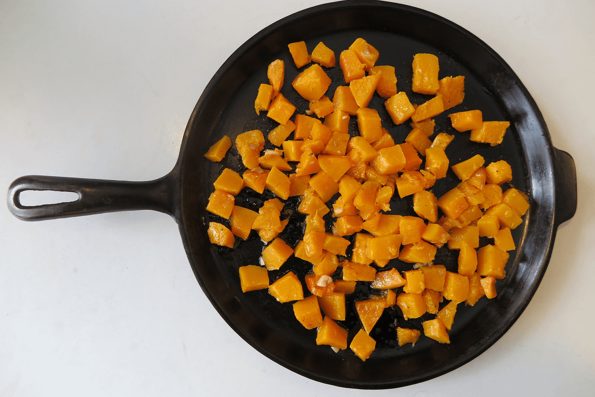 butternut squash cooking in a cast iron skillet