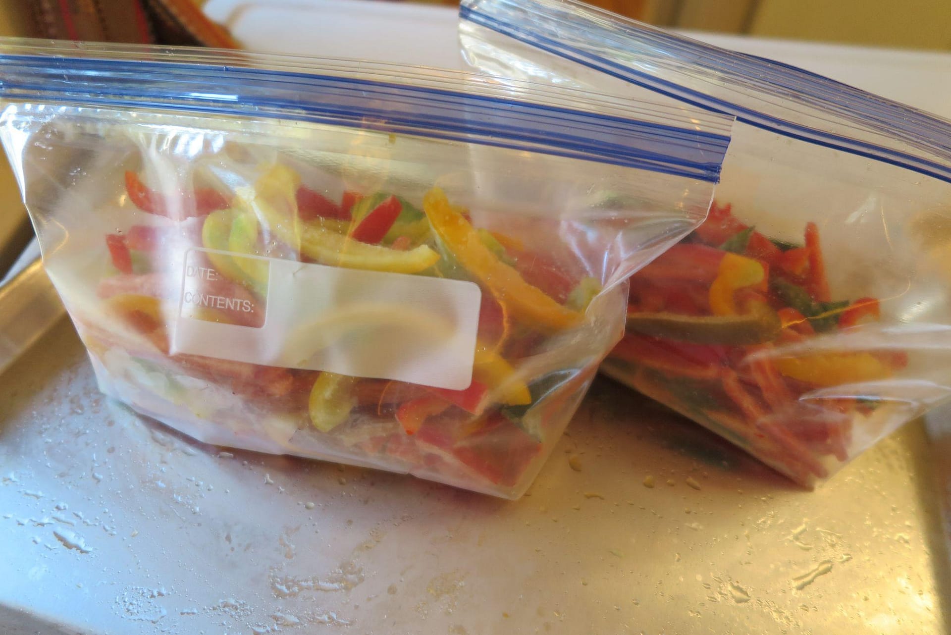 Ziploc bags of sliced bell peppers ready for the freezer